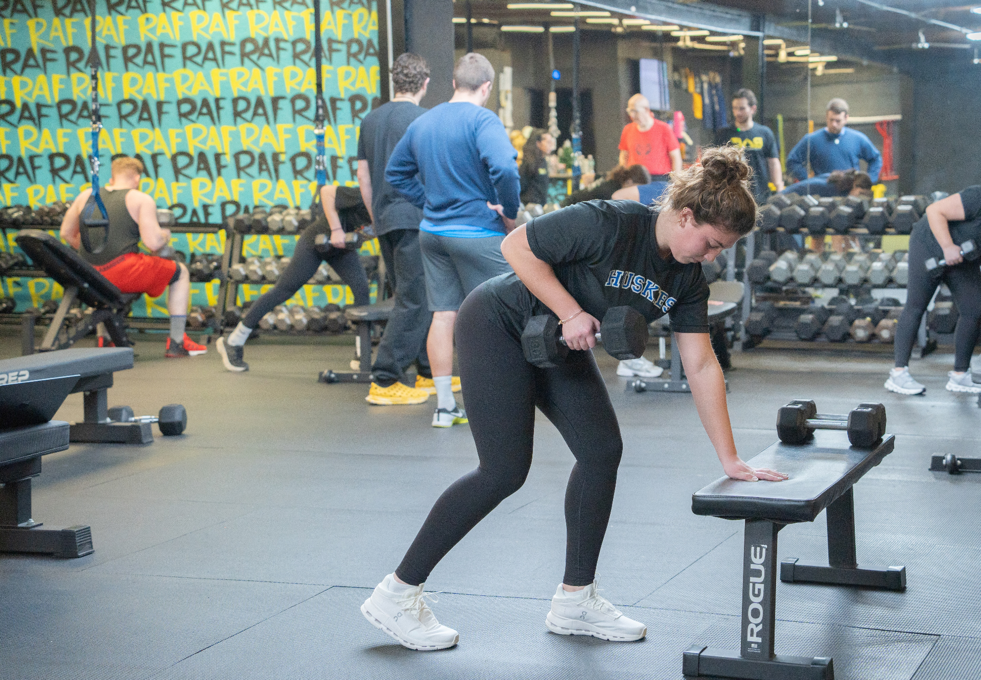 College athletes training on the floor at RAF Strength & Fitness with the RAF wall in the background